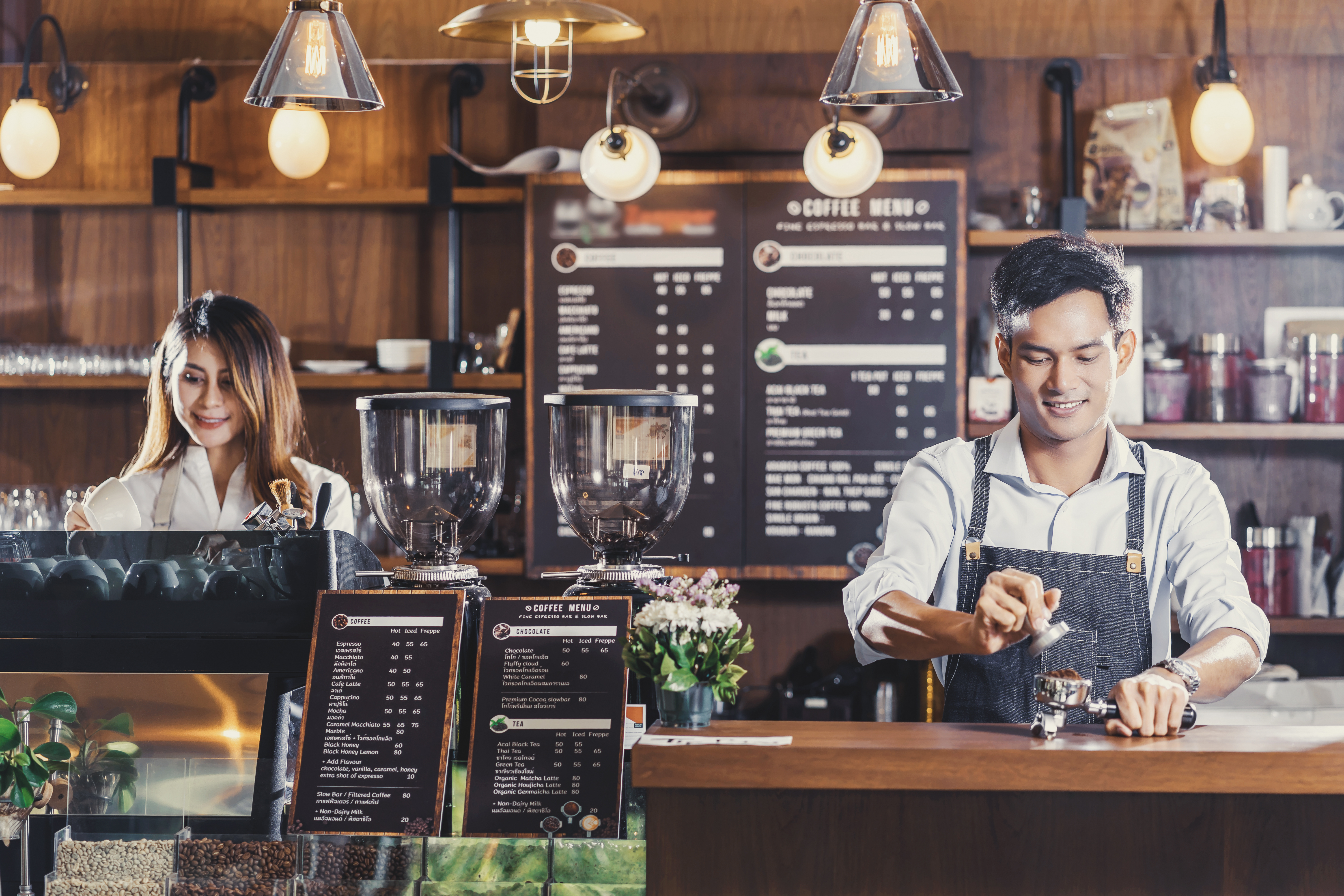 Photograph of Ramona Drive Coffee Shop employees working at the cash register.